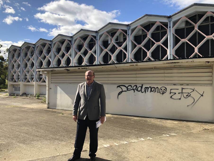 Councillor Charles Strunk outside the derelict building in 2018. Photo: Ruth McCosker