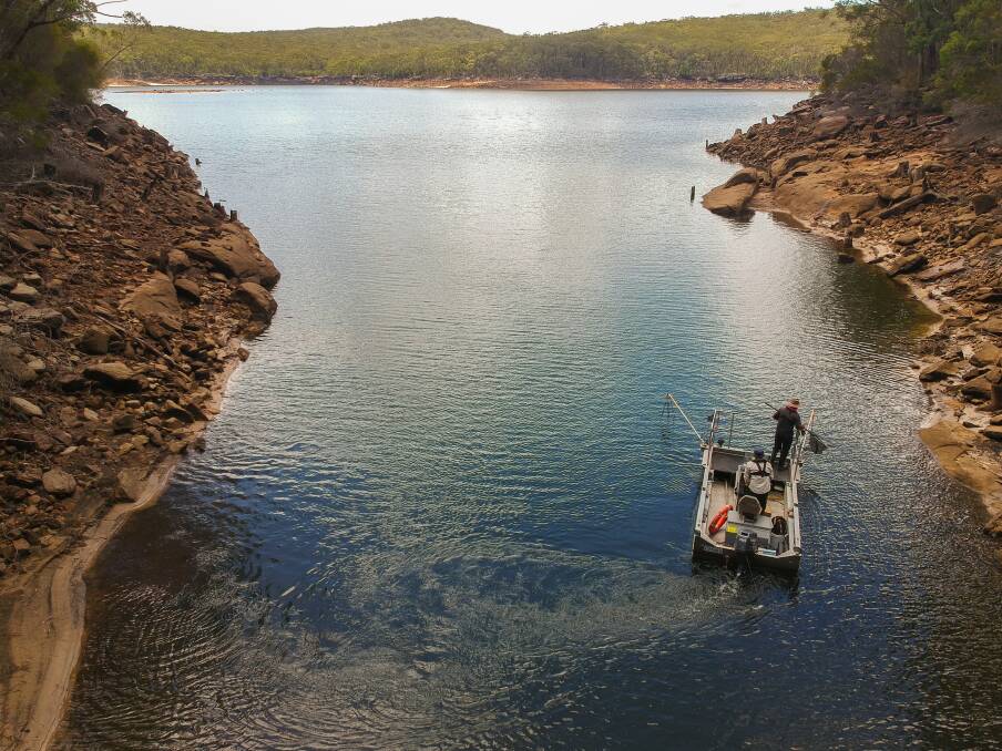 ACT Parks and Conservation aquatic ecologist Matt Beitzel and University of Canberra associate professor Mark Lintermans collect Macquarie perch from Cataract Dam in Sydney.  Photo: Mark Jekabsons
