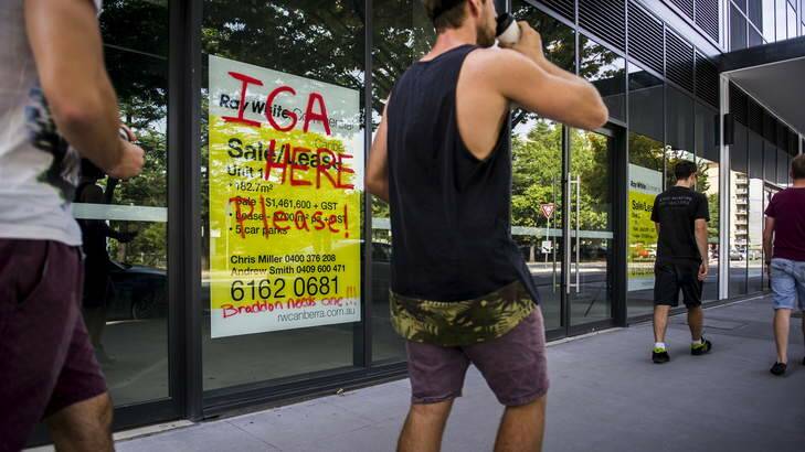 Graffiti saying 'IGA HERE PLEASE! Braddon needs one!!!' on the outside of the under-construction Habitat building in Braddon. Photo: Rohan Thomson