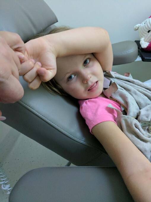 Freyja Christiansen offered a pinky promise to reassure her mum she would be a brave girl for the tests for her cancer. Photo: Supplied