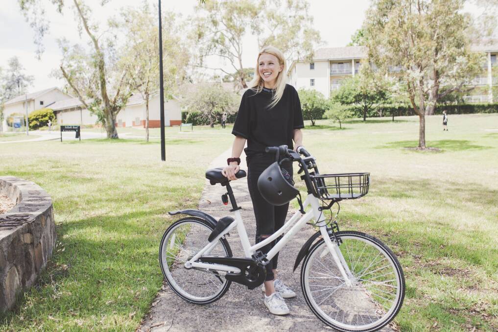 Charlotte England, pictured above, is one of thousands of Canberrans using Airbike to travel around the city.  Photo: Jamila Toderas