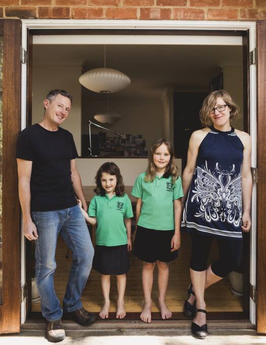 Canberra architect Robbie Gibson has invested into SolarShare, a community run solar farm. Mr Gibson is pictured with his wife Karin Gustavsson, and their children Nelly 6, and Freya 9. Photo: Jamila Toderas