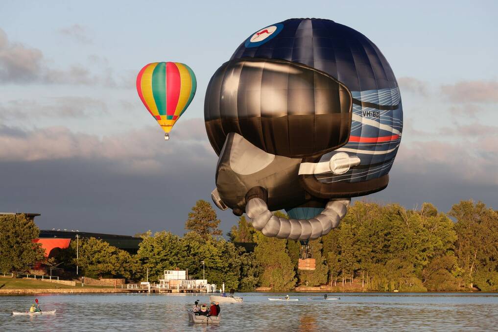 The "RAAF Helmet" hot air balloon, pictured flying over Lake Burley Griffin, will make another appearance at this year's Canberra Balloon Spectacular.  Photo: Alex Ellinghausen
