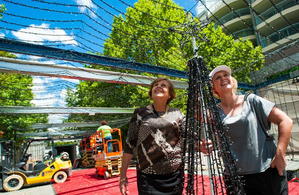 Canberra CBD Limited chief executive officer Jane Easthope and SIDS and Kids ACT chief executive officer Lisa Ridgley watch as the lights come down in City Walk on Thursday. Photo: Elesa Kurtz