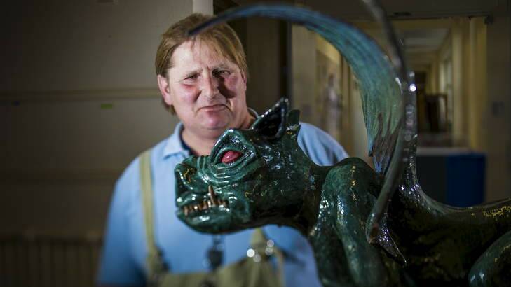 Franz Schroedl with his ceramic gargoyle in the entry at the ANU School of Art. Photo: Rohan Thomson