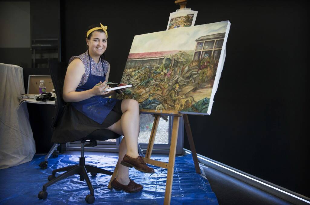 Australian Army Staff Cadet Bethany Gallagher, of the Royal Military College, Duntroon, completes a painting. Photo: Defence