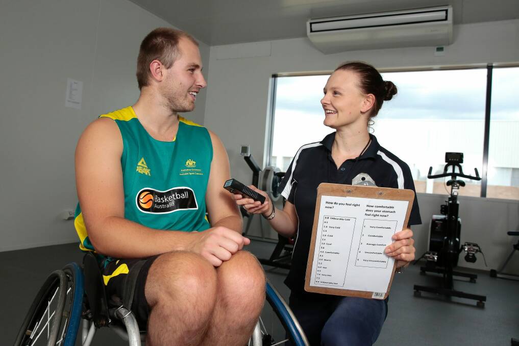 Australian wheelchair basketballer Tim Markcrow with University of Canberra Phd student Peta Forsyth at the Environmental Chamber at UC RISE building. She is researching the thermoregulation and cooling strategies of athletes with spinal cord injuries.  Photo: Jeffrey Chan