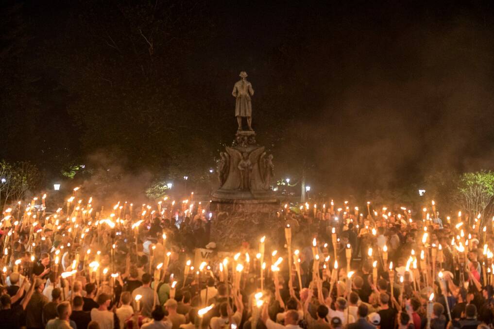 Torch-bearing white nationalists rally around a statue of Thomas Jefferson near the University of Virginia campus in Charlottesville. Photo: New York Times