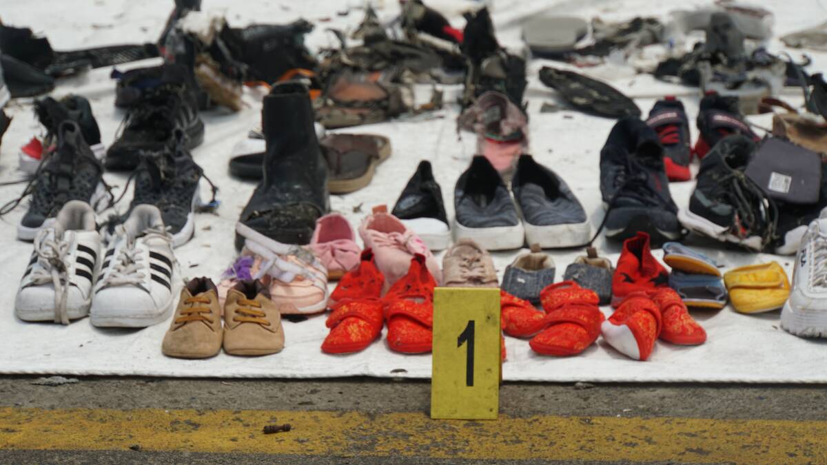 Baby shoes among the debris and personal belongings fished out of the sea by search and rescue teams and lined up at Tanjung Priok crisis centre after the crash of Lion Air flight JT610. Photo: Amilia Rosa