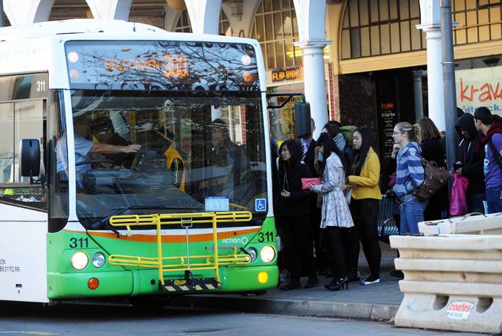 All aboard ... People catch an ACTION bus at Civic interchange yesterday. Photo: Graham Tidy