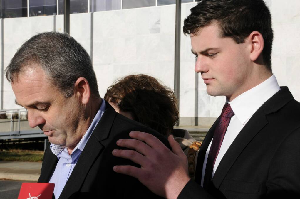 Jack Mitchell rests a hand on his father shoulder as he reads a statement to the media after the verdict. Photo: Alexandra Back