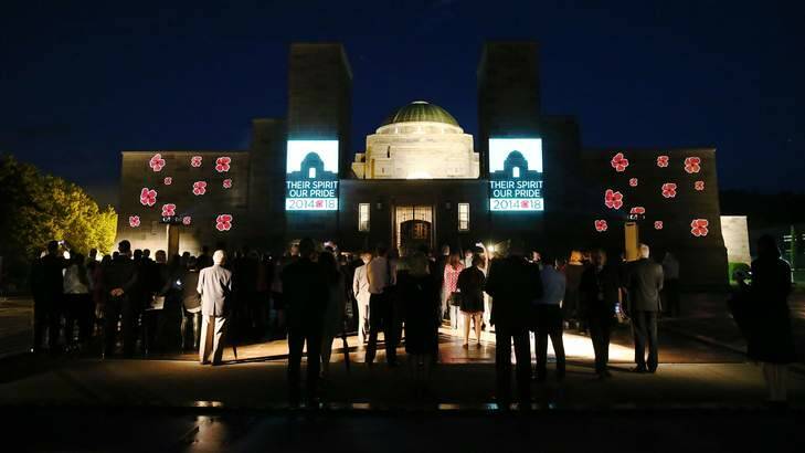 Poppies and the WWI centenary logo are projected on to the Australian War Memorial on a wet Wednesday evening. Photo: Alex Ellinghausen