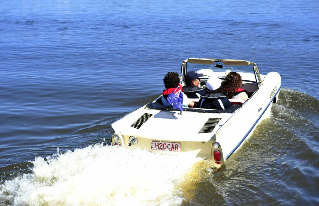 Tony Nassar of Cooma on Lake Burley Griffin in his Amphicar with his wife Rebecca and their two sons back left,  Andareas,15. and Jozeph, 17.  Photo: Melissa Adams
