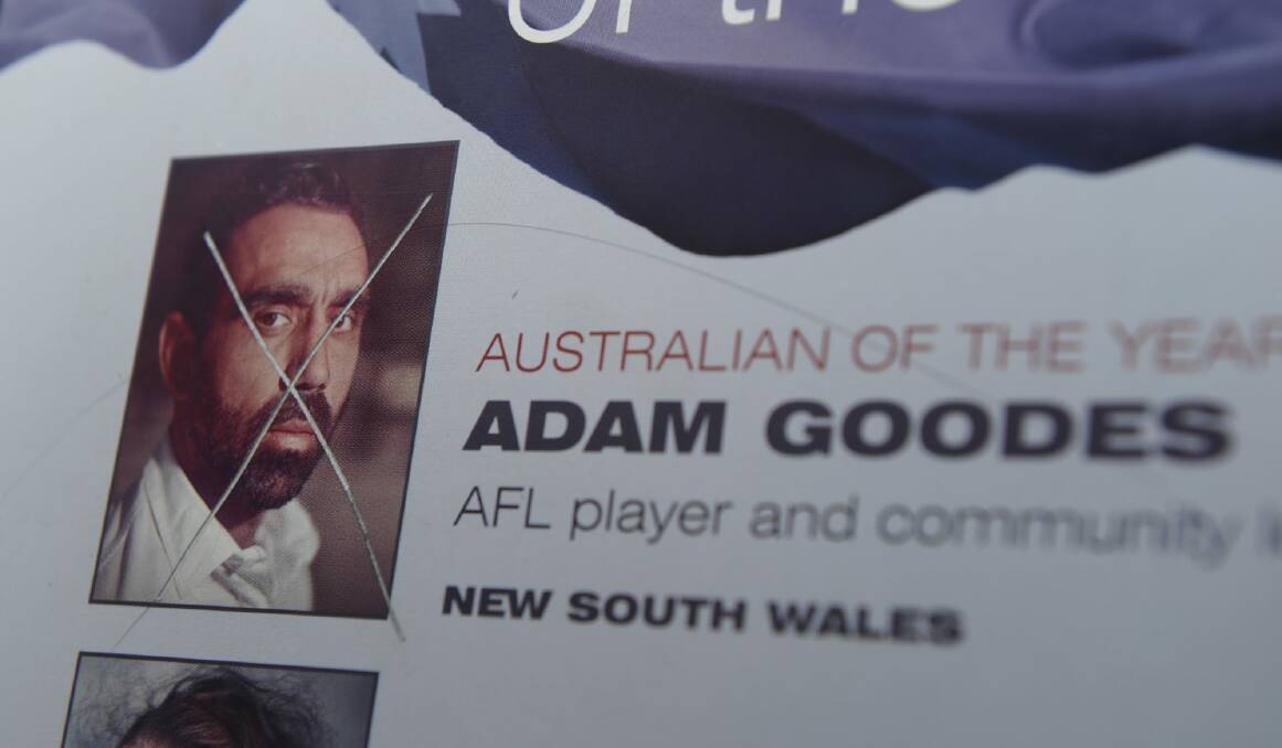 The damaged plaque, on the shores of Lake Burley Griffin, displaying the image of Adam Goodes, Australian of the Year 2014.  Photo: Graham Tidy