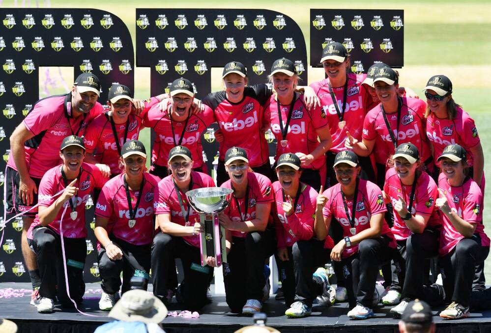 Podium finish: The Sydney Sixers with the WBBL trophy.  Photo: AAP