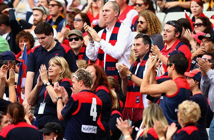 In the thick of it ... Jim Stynes joins the Demons cheer squad for a match against Richmond in 2010. Photo: Getty