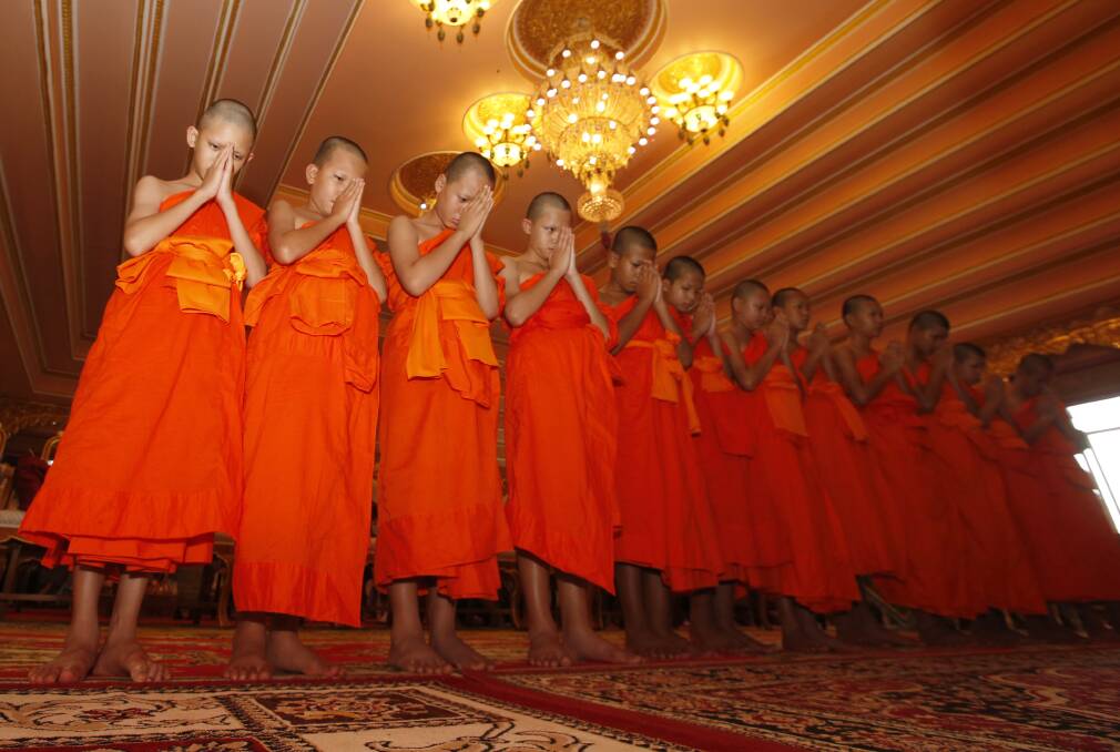 The Wild Boars pray during a ceremony marking the completion of their service as novice Buddhist monks. Photo: AP