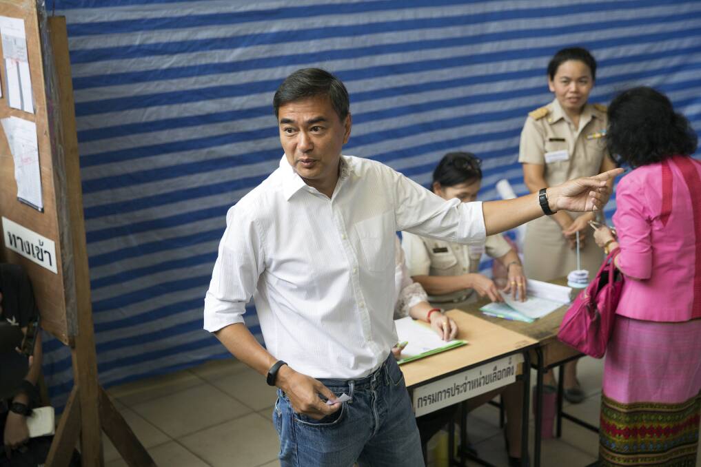 Democrat Party leader Abhisit Vejjajiva gestures as he arrives at a polling station to cast his ballot in Bangkok , Thailand, on Sunday. Photo: AP