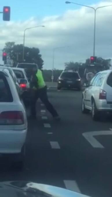 A man punches another driver's car in a bout of road rage in Canberra. Photo: Facebook