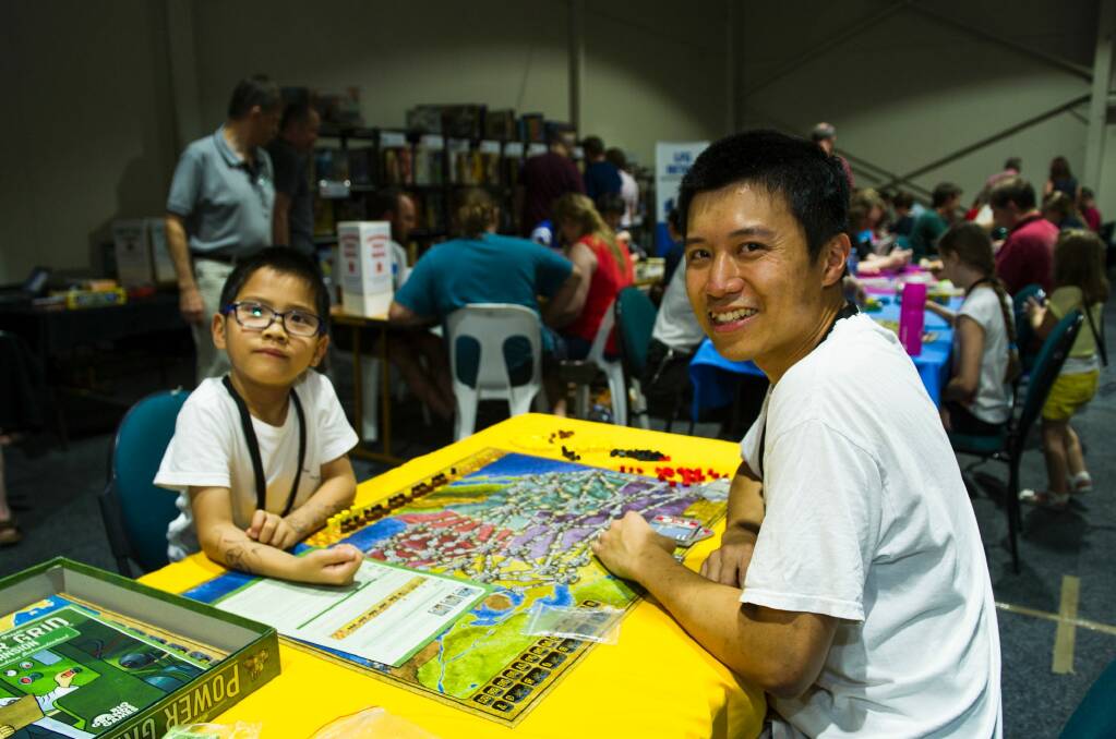 Ronald and Chilok Yu, 6, of Gungahlin play Power Grid from the board game library. Photo: Elesa Kurtz