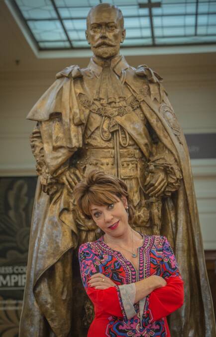 Not happy George: Author Kathy Lette next to the King George V statue at Old Parliament House. She is on a campaign to get more women immortalised as statues #onedaymyplinthwillcome Photo: Karleen Minney