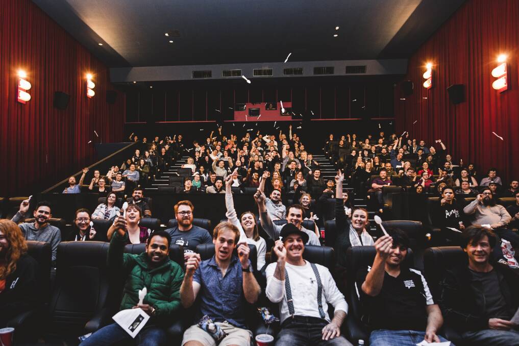 The audience tosses plastic spoons during an interactive screening of 'The Room' at Limelight Cinemas. Photo: Jamila Toderas