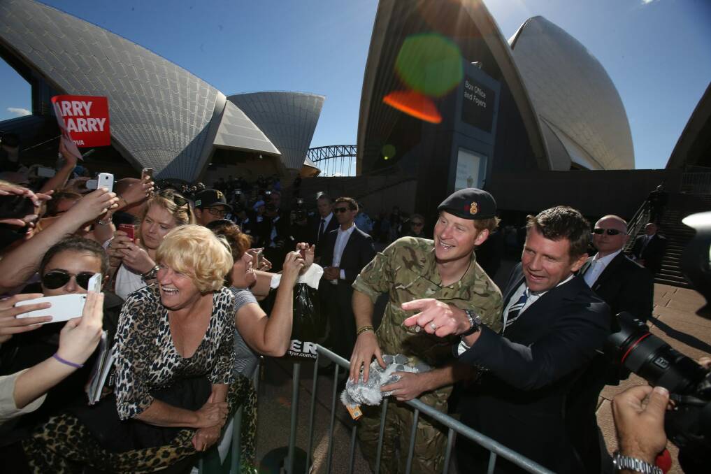 Prince Harry and NSW Premier Mike Baird greet crowds at the Opera House. Photo: Louise Kennerley