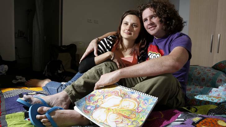 Jessie Doolan and Joel Campbell from Elora Bay holding a picture of their twins have been staying at Ronald McDonald House Canberra since their twins were born premature. Photo: Jeffrey Chan