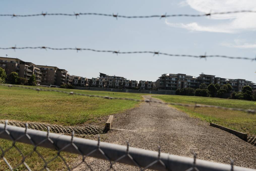 Centenary Park apartments overlook the former landfill site used by Ford motoring company. The fenced-off site was remediated in the 1990s.  Photo: James Brickwood