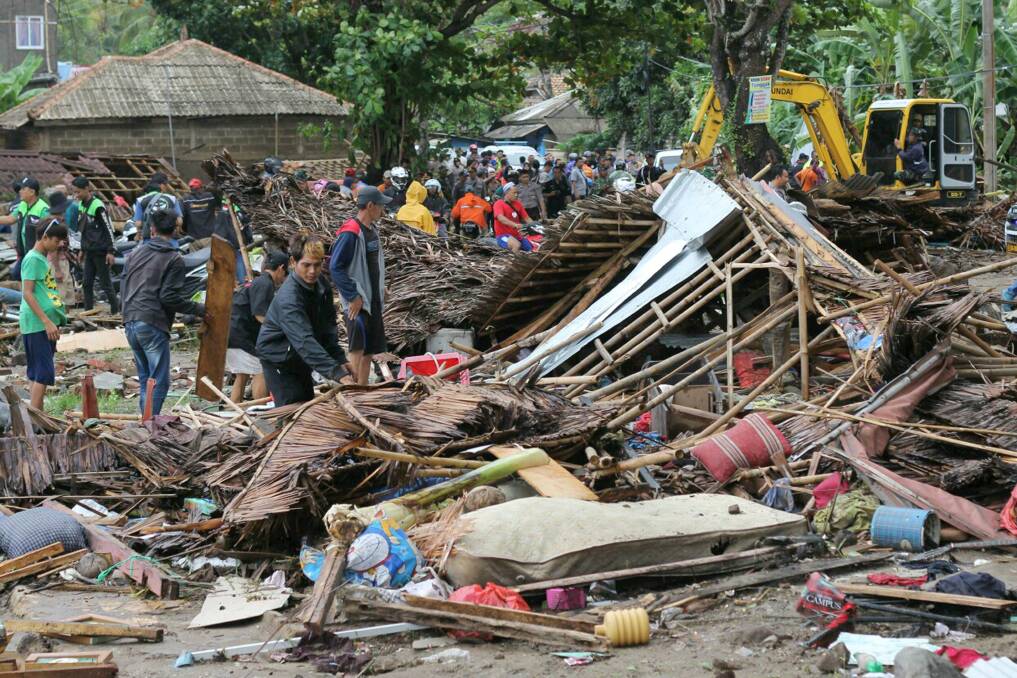 Residents look through rubble of flattened homes.  Photo: AP
