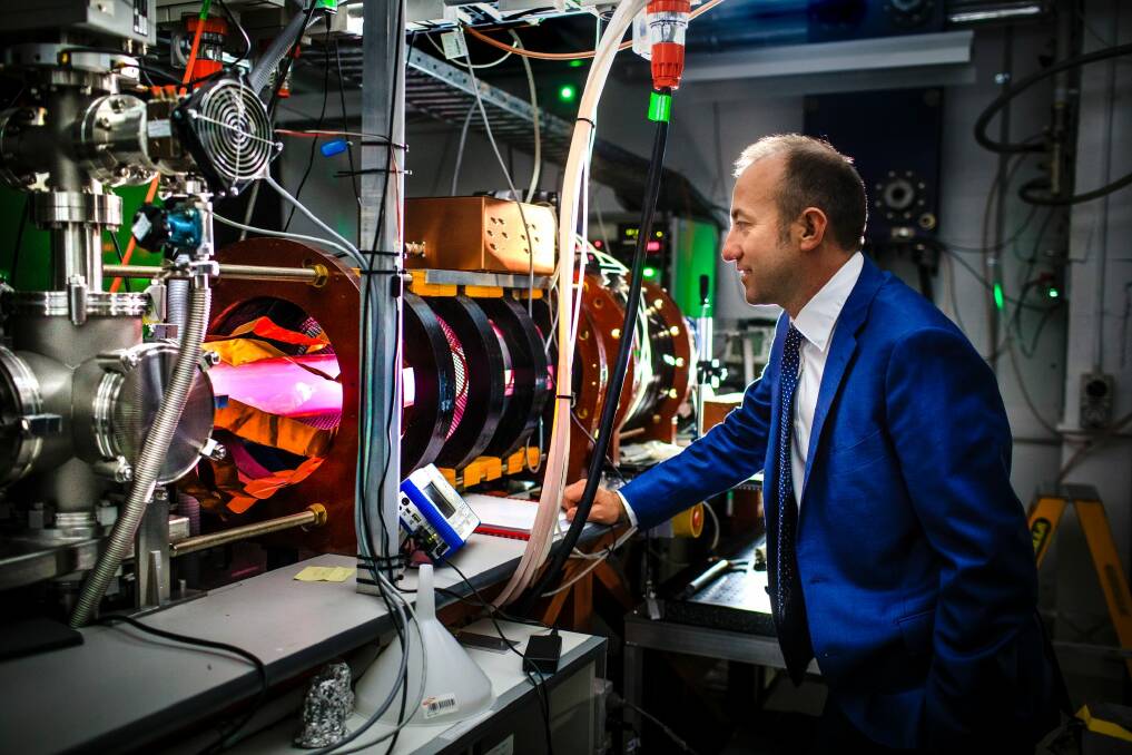 Director of the Australian Plasma Fusion Research Facility at ANU Dr Cormac Corr with the glowing MAGPIE II - a machine used to test plasma interactions.  Photo: Sitthixay Ditthavong
