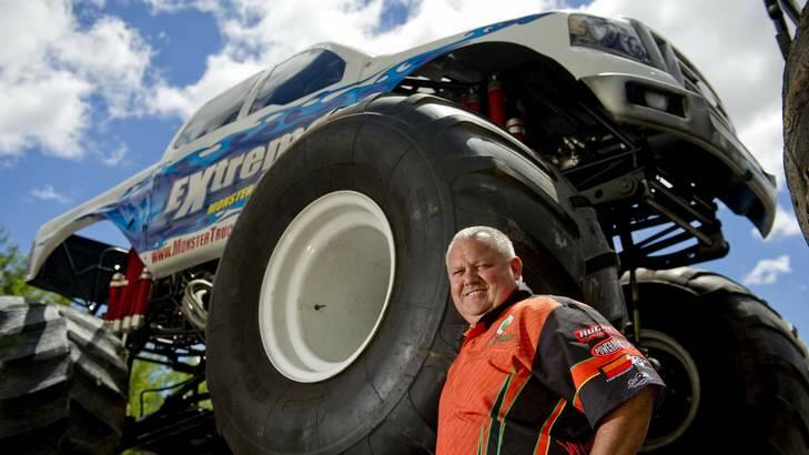 MONSTERS MAN: Kreg Christensen dwarfed by one of his trucks. Photo: JAY CRONAN Photo: Jay Cronan