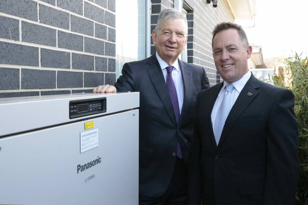 ActewAGL CEO Michael Costello and Panasonic Australia's managing director Paul Reid with a battery storage system at a home in Forde. Photo: Jeffrey Chan