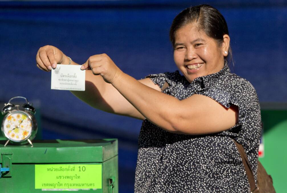 A Thai voter with a ballot paper in her hand, poses at a polling station in Bangkok, Thailand, on Sunday. Photo: AP