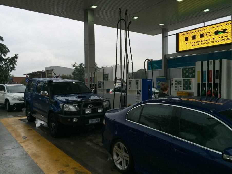 Customers queue for free fuel at Metro petrol station in Fyshwick at noon. Photo: Clare Colley