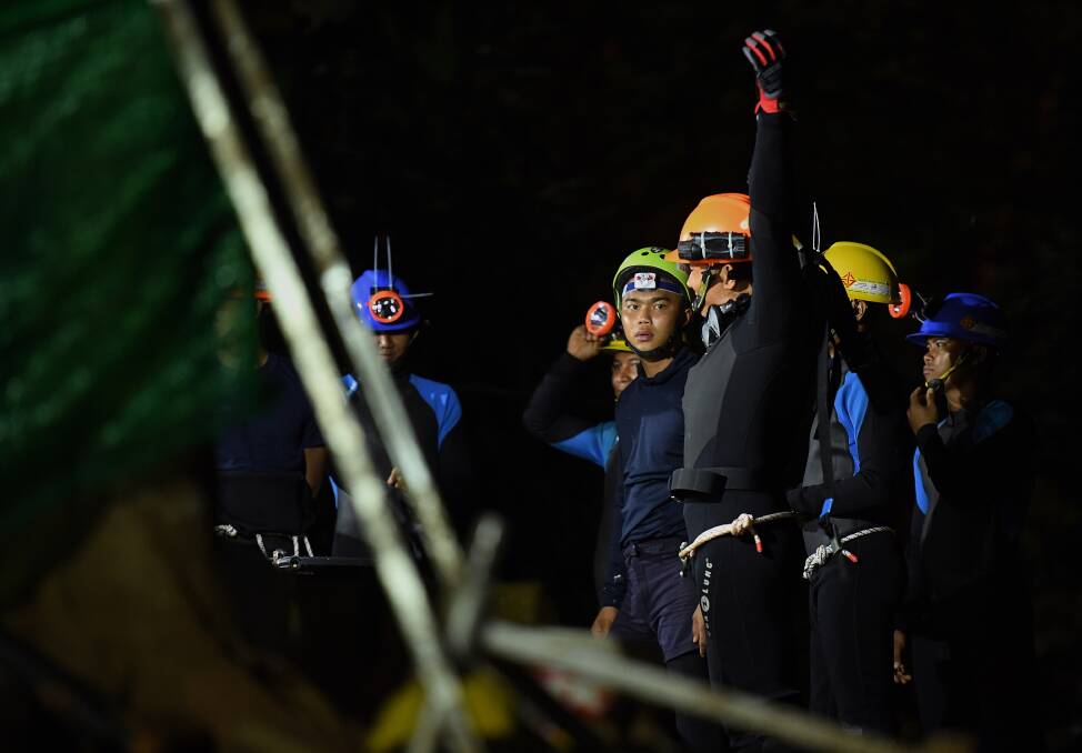 Thai divers prepare to walk into the Tham Luang cave. Photo: Kate Geraghty