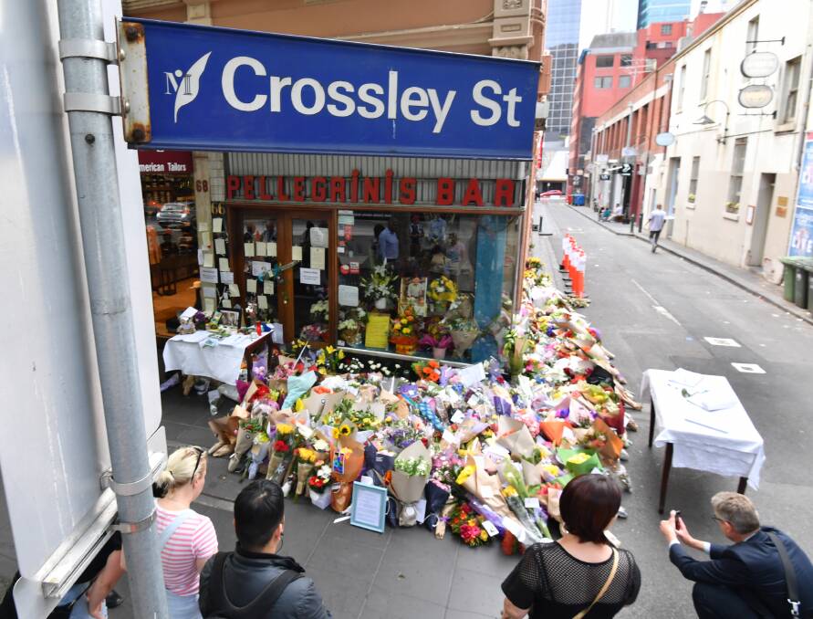 Tributes at Pellegrini's in Melbourne's Bourke Street. Friday's incident in Victoria was cited by Queensland's Attorney-General when announcing the legislation. Photo: Joe Armao