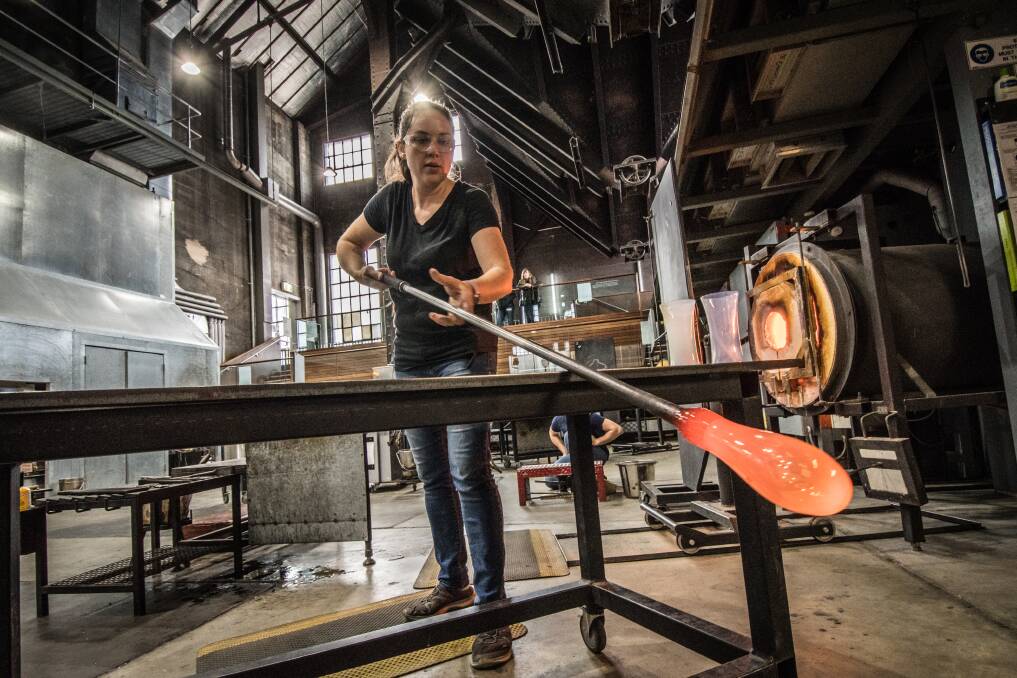 Artist Jacqueline Knight works on some limited-edition tumblers for Winter Glass.  Photo: Karleen Minney
