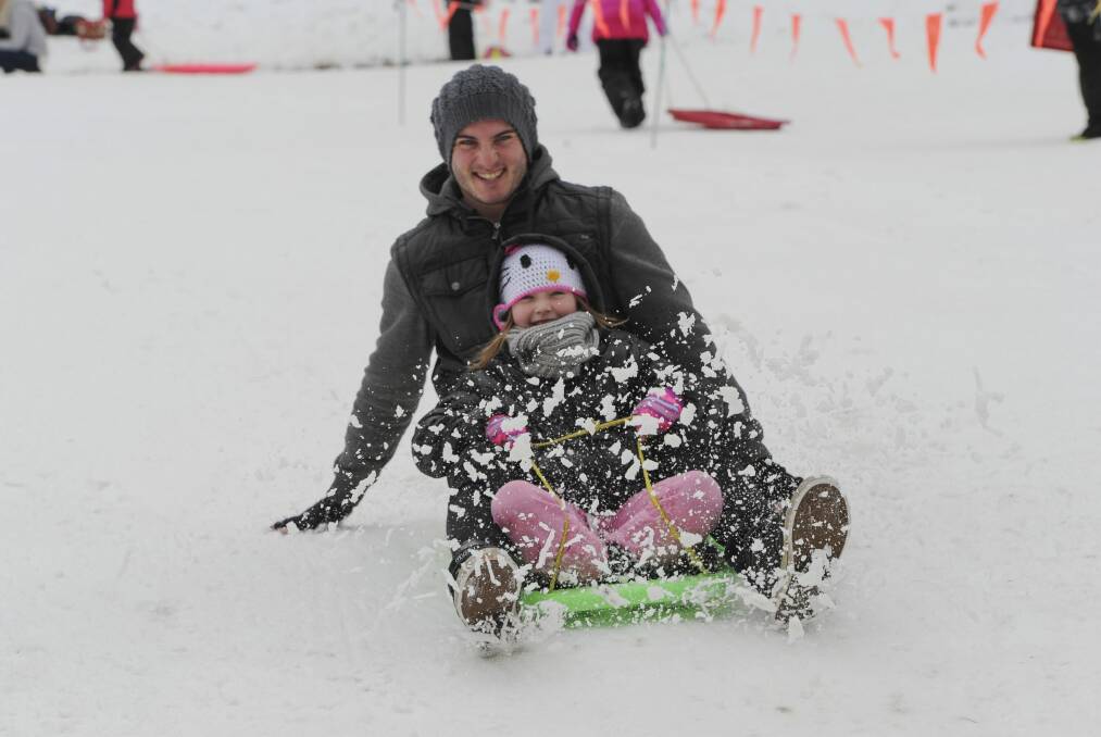 Wollongong's Steven Megson and daughter Khloe, 6, on the toboggan run at Corin Forest Mountain Resort. Photo: Graham Tidy