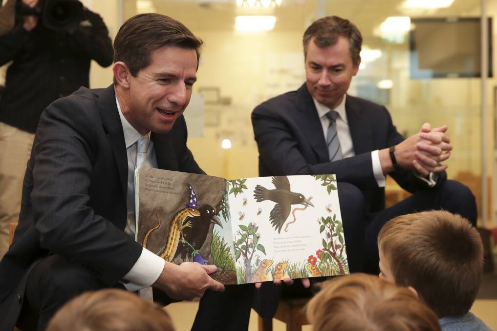 Education Minister Simon Birmingham reads to children at a childcare centre in Canberra. Photo: Alex Ellinghausen