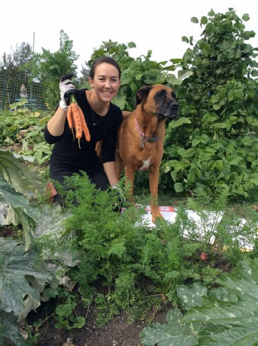 Felicity Buckle and Macey with just harvested carrots.  Photo: Susan Parsons
