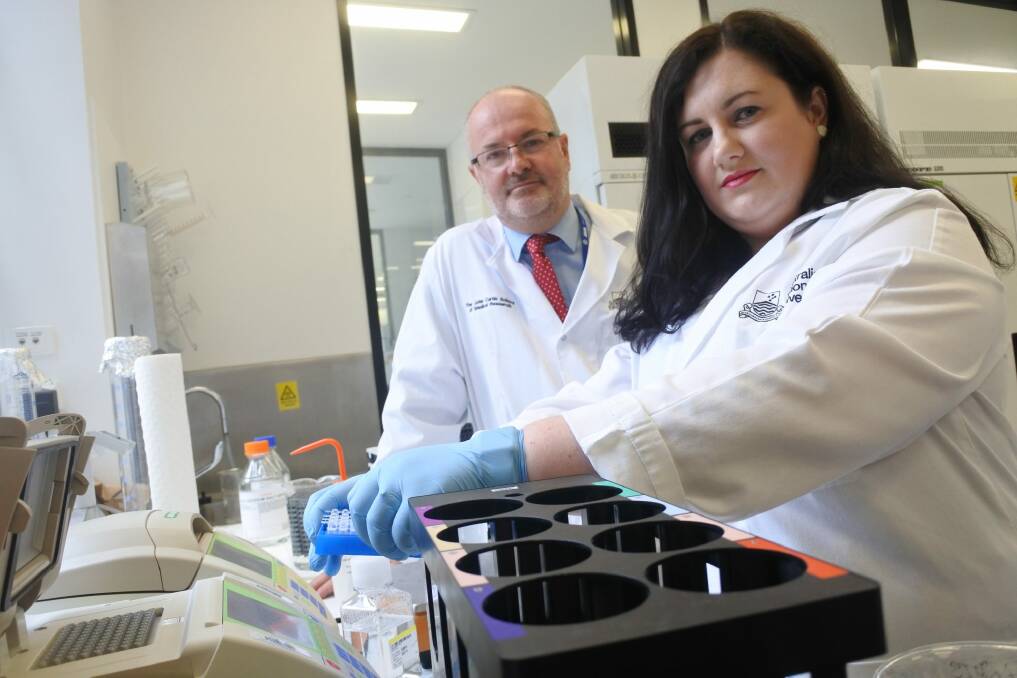 Manager of the Target and Drug Discovery Platform Dr Amee George and ACT Centenary Chair of Cancer Research Professor Ross Hannan in the lab that houses the new robotic system that fast-tracks the development of new drugs to fight cancer and other diseases. Photo: Clare Sibthorpe