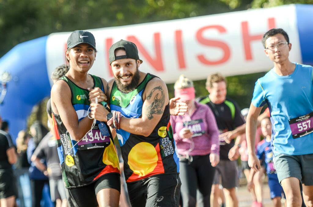 Runners from the Indigenous Marathon Foundation celebrate crossing the finish line. Photo: 90 Seconds