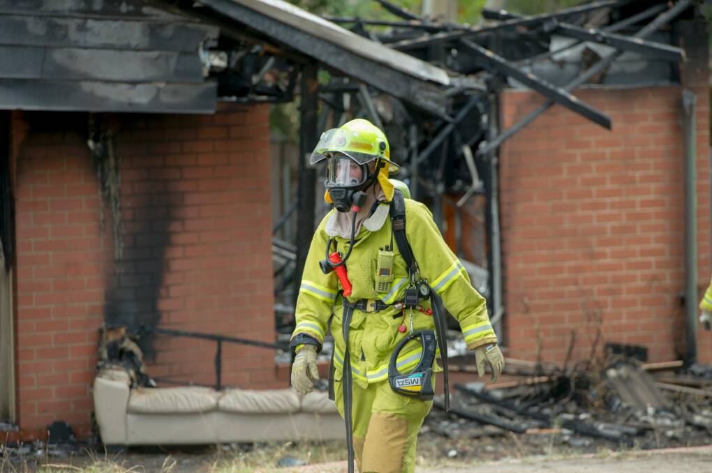 Firefighters at the scene of the house fire on Ranken Loop, Belconnen. Photo: Jay Cronan