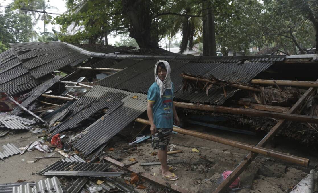 A man inspects his house which was damaged by the tsunami in Carita. Photo: AP