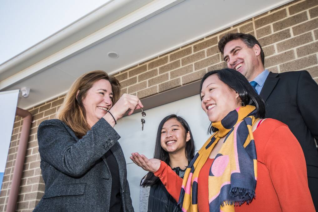 ACT Housing Minister Yvette Berry hands over the first keys to Christine Van and daughter Chloe ,15. Photo: Karleen Minney