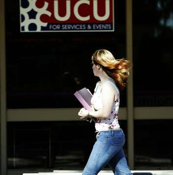 A student walks past the union building at UC. Photo: Louie Douvis