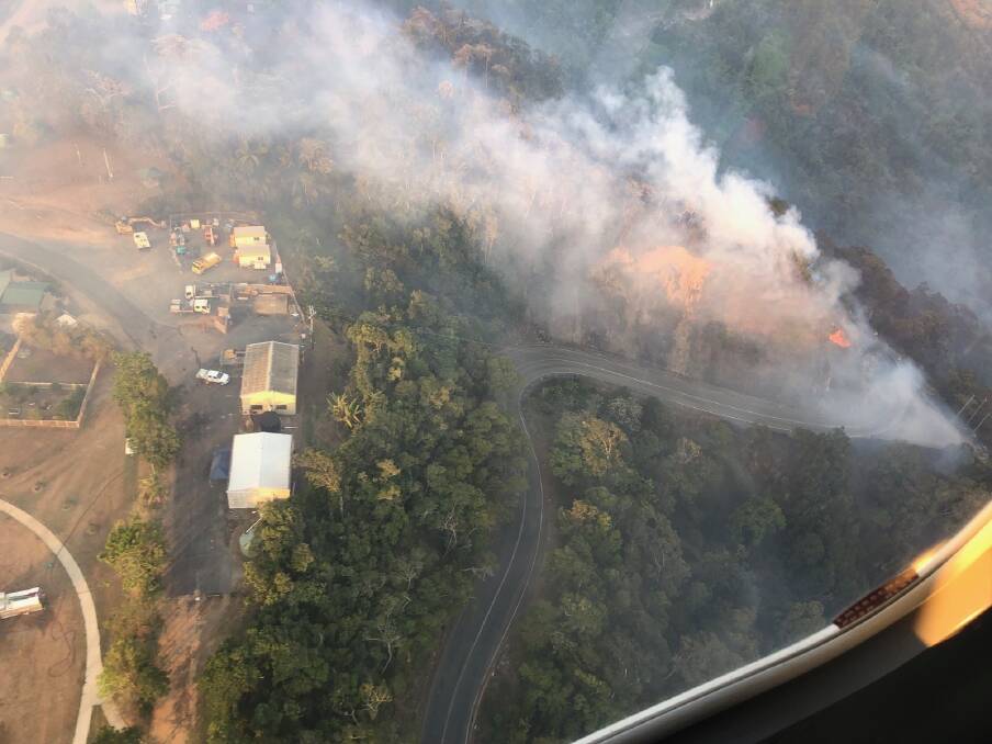 Fire 'roaring' up the hill toward the central Queensland township of Eungella. Photo: RACQ CQ Rescue.
