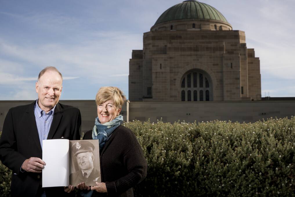 Peter and Sue Willis outside the Australian War Memorial with a picture of their late father Ken, who has been awarded France's highest military honour. Photo: Sitthixay Ditthavong