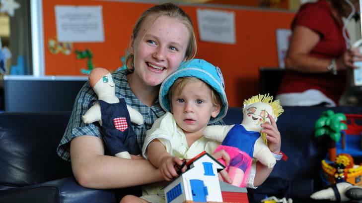 Students from Trinity Christian School, visit The Canberra Hospital paediatric ward to deliver hand made dolls to the young patients. 2 year old Ngunnawal boy, Logan Fort, with year 9 student, 15 year old Alex Kilpatrick of Banks. Photo: Graham Tidy